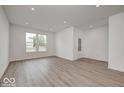 Bright and spacious living room with large windows and hardwood floors at 5715 Cr W 750 N, McCordsville, IN 46055