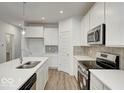 Modern kitchen with white cabinets, quartz countertops, and stainless steel appliances at 5715 Cr W 750 N, McCordsville, IN 46055