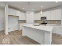 Modern kitchen with white cabinets, quartz countertops, and stainless steel appliances at 5715 Cr W 750 N, McCordsville, IN 46055