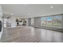 Open living room with hardwood floors and view into kitchen at 6233 Lafayette Rd, Indianapolis, IN 46278