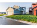 Two-car garage with white doors and a grassy backyard at 9310 Anthem Ave, Plainfield, IN 46168