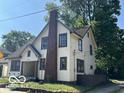 Two-story home with brick chimney and mature trees at 819 E 49Th St, Indianapolis, IN 46205