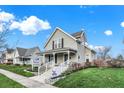 Charming 2-story home with a porch and landscaped lawn at 621 N State St, Greenfield, IN 46140