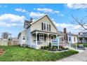 Beige siding, front porch, and well-maintained lawn at 621 N State St, Greenfield, IN 46140