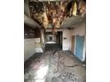 Damaged kitchen with exposed ceiling and debris on the floor at 904 N Penn St, Muncie, IN 47303