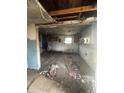 Severely damaged kitchen with exposed ceiling and debris at 904 N Penn St, Muncie, IN 47303