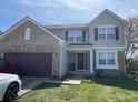 Two-story house with brick and siding, attached garage, and landscaped lawn at 6951 Governors Point Blvd, Indianapolis, IN 46217