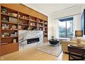 Spacious living room boasts a marble fireplace, built-in shelving, and hardwood floors at 855 N East St # 303-B, Indianapolis, IN 46202