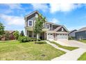 Two story house with gray siding, brick accents, and a three-car garage at 1340 Turner Trace N Pl, Avon, IN 46123