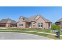 Brick house with gray roof, landscaping, and a mailbox at 4212 Stone Lake Dr, Zionsville, IN 46077
