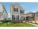 Two-story house with a green door and walkway at 5733 Arcade Blvd, McCordsville, IN 46055