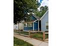 Newly renovated blue house with a wooden fence and small front yard at 221 Kansas St, Indianapolis, IN 46225