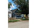 Newly renovated blue house with a wooden fence and small front yard at 221 Kansas St, Indianapolis, IN 46225
