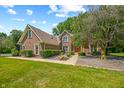 Brick house with a red door and landscaped yard at 2508 W Indian Creek Rd, Trafalgar, IN 46181