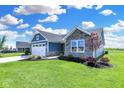 Blue and gray house with stone accents and landscaping at 6941 E Bean Blossom Dr, Camby, IN 46113