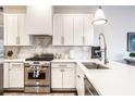 Modern kitchen with white cabinets, marble backsplash, and stainless steel appliances at 1336 Central Ave, Indianapolis, IN 46202