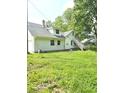 White house with gray roof, detached garage, and a large grassy yard at 1515 S Park Ave, Alexandria, IN 46001