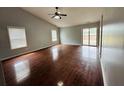 Bright living room featuring hardwood floors and sliding glass door access to backyard at 7020 Ira Ct, Indianapolis, IN 46217