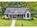 House with wrap around porch, nestled in a wooded area at 5722 Slippery Elm Shoot Rd, Morgantown, IN 46160