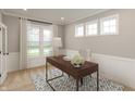Home office with a desk, large windows, and neutral color palette at 15287 Garden Mist Pl, Fishers, IN 46037