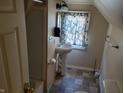 Small bathroom with pedestal sink and tub at 3310 N Kenwood Ave, Indianapolis, IN 46208