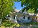 White bungalow with gray brick base and porch at 3310 N Kenwood Ave, Indianapolis, IN 46208