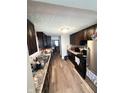 Kitchen with dark wood cabinets and laminate flooring at 531 N Alton Ave, Indianapolis, IN 46222