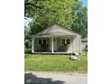 Quaint house with a covered porch and a large front yard at 3912 Terrace Ave, Indianapolis, IN 46203