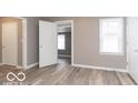 Simple bedroom with hardwood floors and neutral walls at 3755 N Hawthorne Ln, Indianapolis, IN 46218