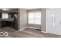 Modern kitchen with stainless steel appliances and vinyl flooring at 3755 N Hawthorne Ln, Indianapolis, IN 46218