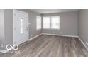 Bright living room featuring hardwood floors and large windows at 3755 N Hawthorne Ln, Indianapolis, IN 46218