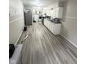 Eat-in kitchen features white cabinets and vinyl flooring at 533 Lynn St, Indianapolis, IN 46222