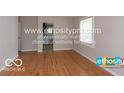 Hardwood floors, neutral walls, and view of kitchen at 3521 N Riley Ave, Indianapolis, IN 46218