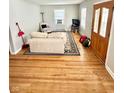 Living room with hardwood floors and beige sofa at 1618 N Linwood Ave, Indianapolis, IN 46218