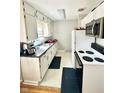 Bright kitchen with white cabinets and wood floors at 1618 N Linwood Ave, Indianapolis, IN 46218