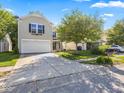 Two-story house with a white garage door and landscaped yard at 917 Balto Dr, Shelbyville, IN 46176