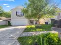 Two-story house with a white garage door and landscaped yard at 917 Balto Dr, Shelbyville, IN 46176