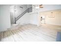 Open living room with hardwood floors and staircase at 2424 N Willow Way, Indianapolis, IN 46268