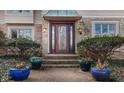 Elegant front door entrance with stone details and landscaping at 6835 Fox Lake S Dr, Indianapolis, IN 46278