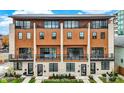 Three-story modern townhouses with wood and brick exterior, balconies, and landscaping at 527 E North St, Indianapolis, IN 46204