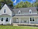 Newly renovated farmhouse with front porch and landscaping at 22133 State Road 37 N, Noblesville, IN 46060