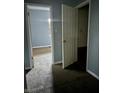 A hallway with gray walls and brown carpet, leading to bedrooms at 642 N Oxford St, Indianapolis, IN 46201