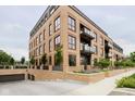 Multi-unit building with brick exterior, balconies, and underground parking at 877 N East St # 104, Indianapolis, IN 46202