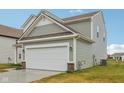 Gray sided two story home with a two-car garage at 2135 Rosemont Dr, Columbus, IN 47201