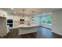 Modern kitchen featuring white cabinets, island, and stainless steel appliances at 6272 Willow Branch Way, Plainfield, IN 46168