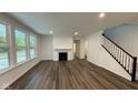 Bright living room with hardwood floors, fireplace, and large windows at 6272 Willow Branch Way, Plainfield, IN 46168