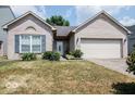 Brick ranch home with attached two-car garage and landscaped yard at 3285 Lakestream Dr, Columbus, IN 47201