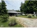 Gray house with landscaping and gravel driveway at 3500 W 30Th St, Muncie, IN 47302