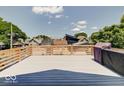 Spacious rooftop deck with city views, wooden railings, and a built-in grill at 1544 Hoyt Ave, Indianapolis, IN 46203