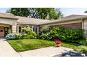 Landscaped front yard with lush greenery and flowers at 504 Bent Tree Ln, Indianapolis, IN 46260